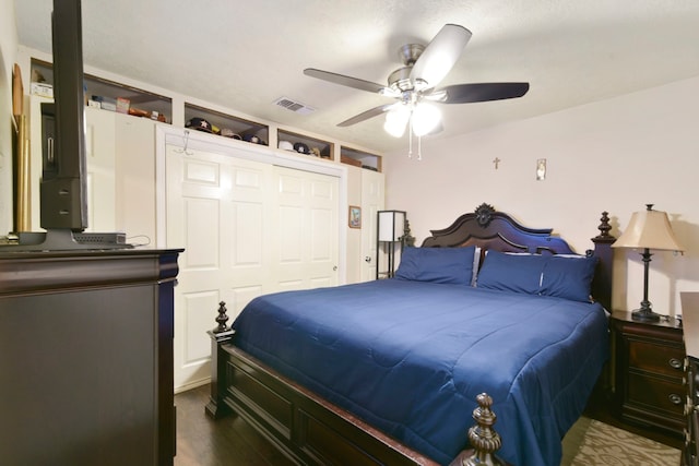 315 E Adoue St, Baytown, TX 77520 - bedroom featuring dark wood-style flooring, a closet, and a ceiling fan