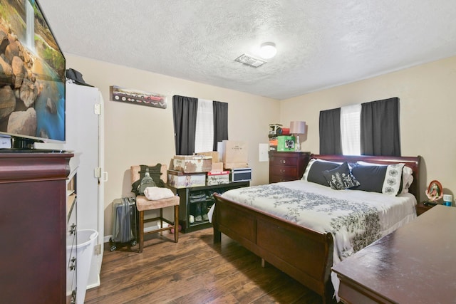 315 E Adoue St, Baytown, TX 77520 - bedroom featuring a textured ceiling and wood finished floors