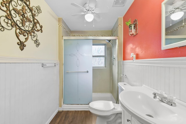 315 E Adoue St, Baytown, TX 77520 - full bath featuring wainscoting, wood finished floors, a ceiling fan, a stall shower, and vanity