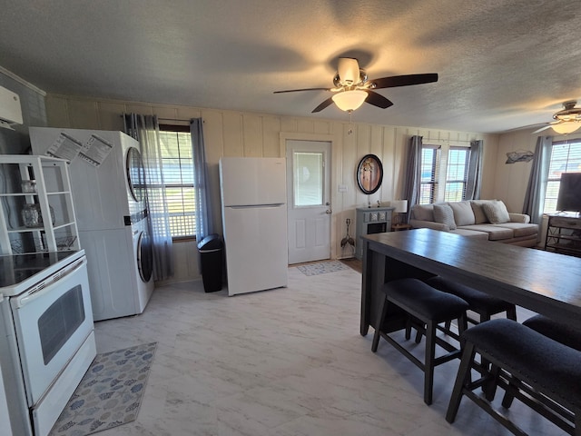 714 Caisson St, Surfside Beach, TX 77541 - kitchen featuring white appliances, a ceiling fan, a textured ceiling, and light marble finish flooring