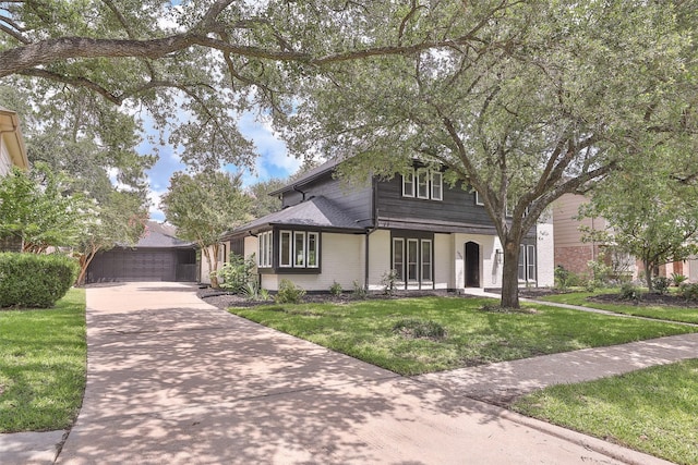 1711 Mossy Stone Dr, Houston, TX 77077 - view of front of home featuring a front yard, brick siding, and a garage