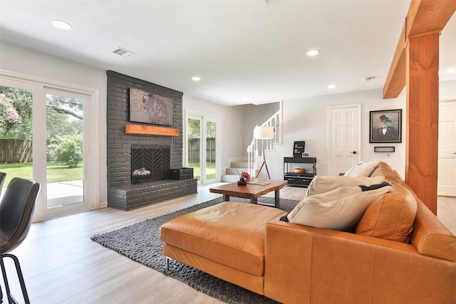 1711 Mossy Stone Dr, Houston, TX 77077 - living area with wood finished floors, recessed lighting, and a brick fireplace