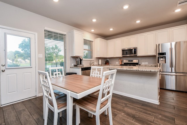 18534 Ariat Dr, Cypress, TX 77429 - dining area featuring dark wood-style floors and recessed lighting