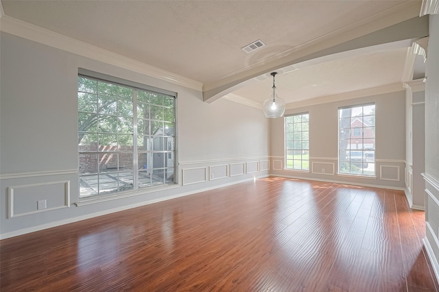 3402 Santa Catalina Ct, Katy, TX 77450 - spare room with a decorative wall, wood finished floors, ornamental molding, wainscoting, and arched walkways