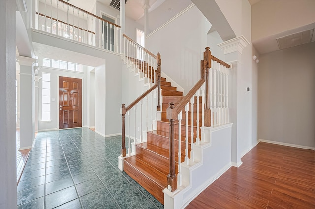 3402 Santa Catalina Ct, Katy, TX 77450 - entryway featuring a high ceiling, stairs, decorative columns, arched walkways, and tile patterned floors