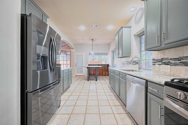 3402 Santa Catalina Ct, Katy, TX 77450 - kitchen featuring appliances with stainless steel finishes, gray cabinetry, tasteful backsplash, light tile patterned flooring, and recessed lighting