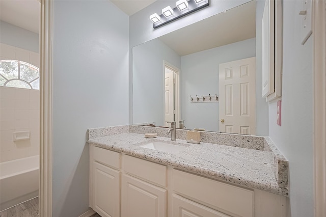 3402 Santa Catalina Ct, Katy, TX 77450 - bathroom featuring vanity, wood finished floors, and bathing tub / shower combination