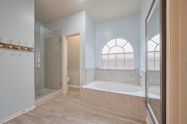 3402 Santa Catalina Ct, Katy, TX 77450 - bathroom with a shower stall, a bath, and wood finished floors