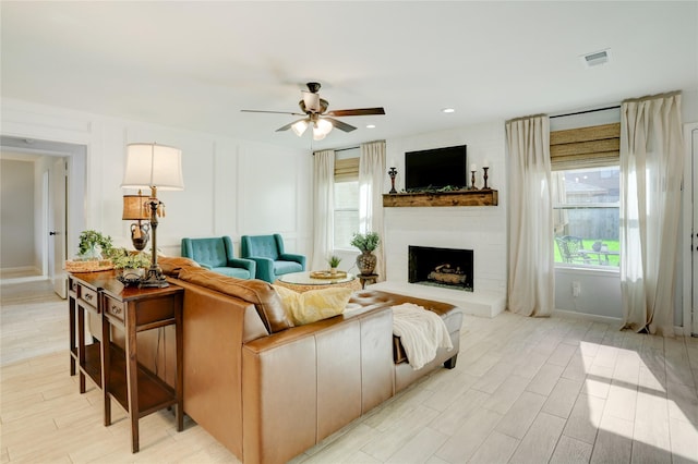 2510 Trailside Ct, Sugar Land, TX 77479 - living area with a fireplace, ceiling fan, and light wood finished floors
