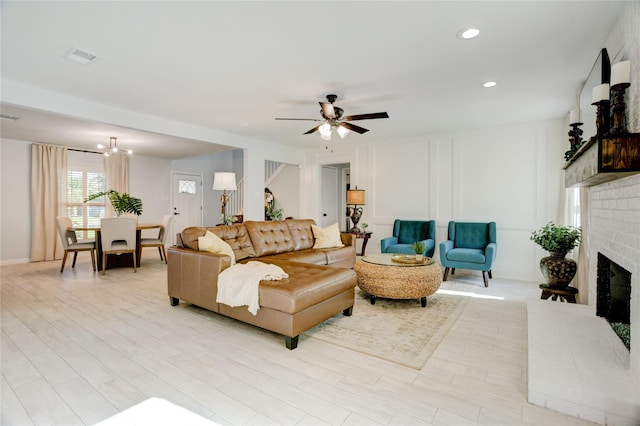 2510 Trailside Ct, Sugar Land, TX 77479 - living area with a fireplace, a ceiling fan, light wood finished floors, recessed lighting, and a decorative wall