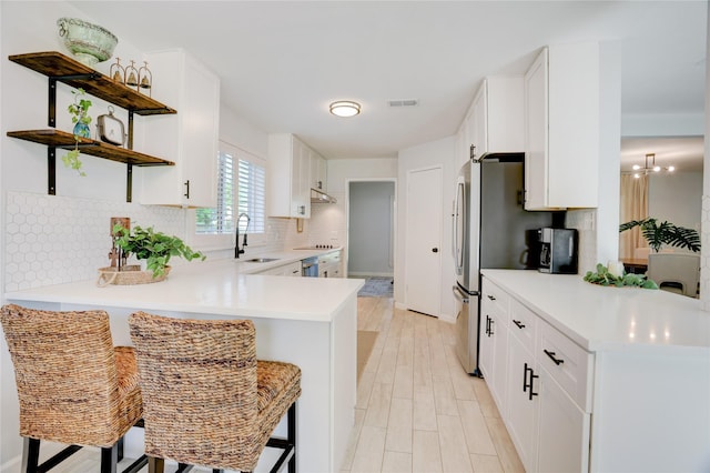 2510 Trailside Ct, Sugar Land, TX 77479 - kitchen with open shelves, a peninsula, light countertops, backsplash, and white cabinetry