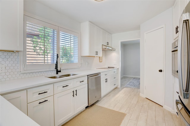 2510 Trailside Ct, Sugar Land, TX 77479 - kitchen featuring stainless steel dishwasher, decorative backsplash, black electric cooktop, white cabinetry, and light countertops