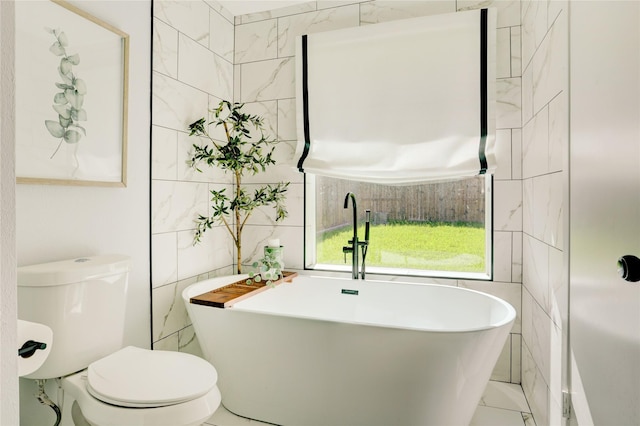 2510 Trailside Ct, Sugar Land, TX 77479 - full bathroom featuring tile walls, a freestanding tub, and marble look tile flooring