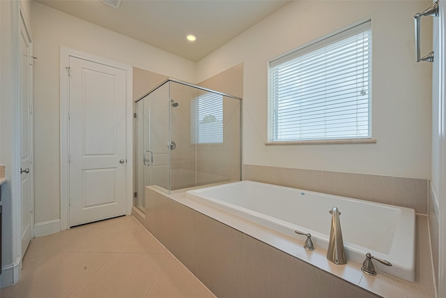 1035 E 28th St, Houston, TX 77009 - bathroom with a stall shower, tile patterned floors, a garden tub, and recessed lighting