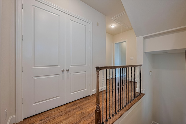 1035 E 28th St, Houston, TX 77009 - hallway with attic access, wood finished floors, and an upstairs landing
