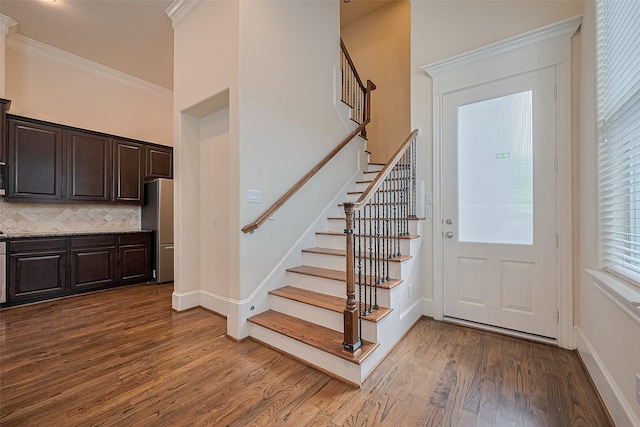 1035 E 28th St, Houston, TX 77009 - entrance foyer with stairway, dark wood finished floors, and crown molding