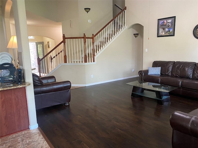 8615 Debbie Terrace Dr, Cypress, TX 77433 - living area featuring arched walkways, stairs, wood finished floors, and a high ceiling