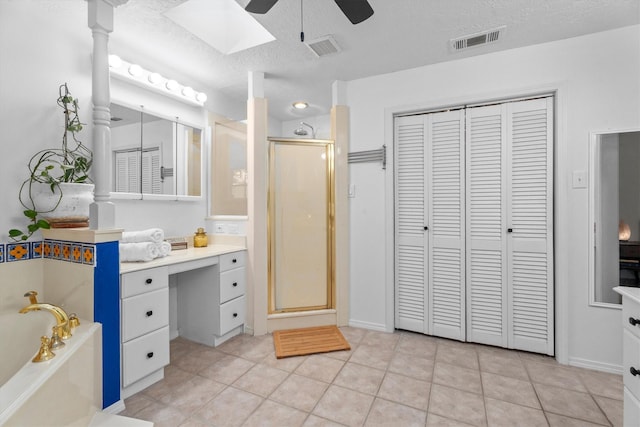 4638 Deer Point Dr, Spring, TX 77389 - bathroom with a closet, a ceiling fan, a garden tub, a shower stall, and a skylight