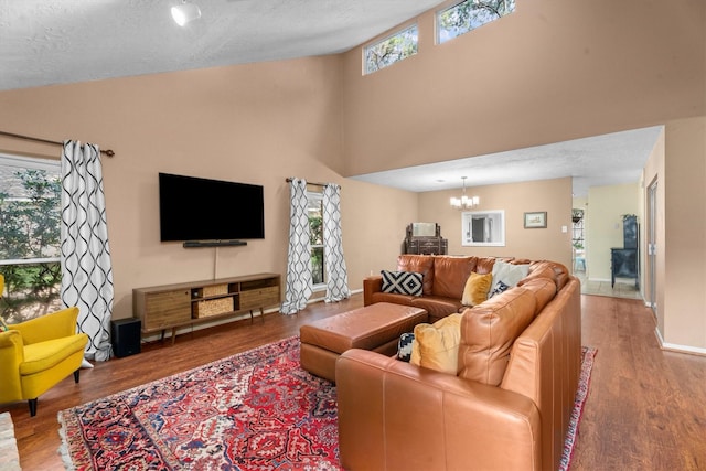 4638 Deer Point Dr, Spring, TX 77389 - living area featuring wood finished floors, a chandelier, a textured ceiling, and a high ceiling