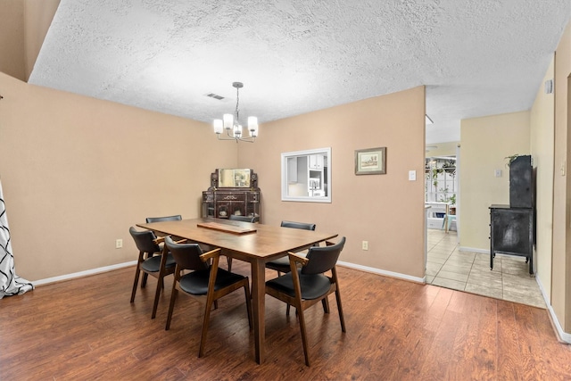 4638 Deer Point Dr, Spring, TX 77389 - dining space with a chandelier, a textured ceiling, and wood finished floors