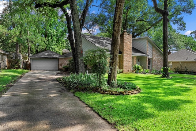 4638 Deer Point Dr, Spring, TX 77389 - mid-century inspired home featuring a chimney, a front yard, driveway, and brick siding