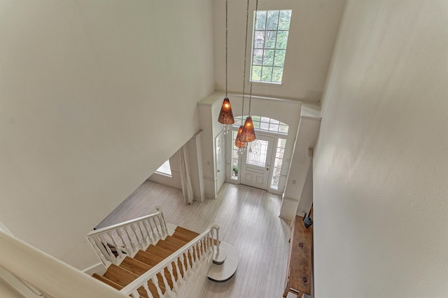 58 E Coldbrook Cir, The Woodlands, TX 77381 - entrance foyer with healthy amount of natural light, a towering ceiling, stairway, and wood finished floors