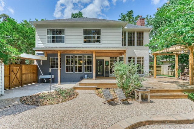 58 E Coldbrook Cir, The Woodlands, TX 77381 - back of house with a wooden deck, a chimney, a patio area, and a pergola