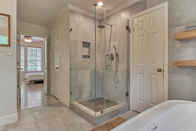 58 E Coldbrook Cir, The Woodlands, TX 77381 - bathroom with crown molding, a soaking tub, ensuite bath, a stall shower, and tile patterned floors