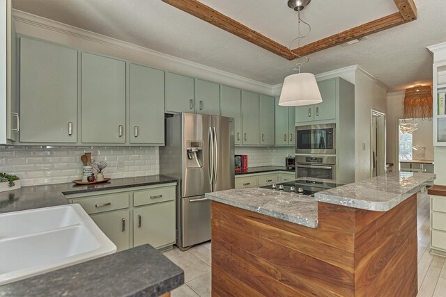 58 E Coldbrook Cir, The Woodlands, TX 77381 - kitchen with appliances with stainless steel finishes, green cabinets, crown molding, decorative backsplash, and a center island