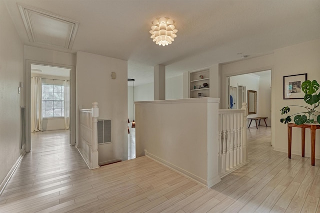 58 E Coldbrook Cir, The Woodlands, TX 77381 - hallway featuring an upstairs landing, attic access, light wood finished floors, and built in shelves