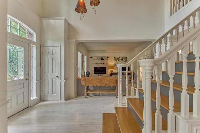 58 E Coldbrook Cir, The Woodlands, TX 77381 - entryway featuring a towering ceiling, stairway, and wood finished floors