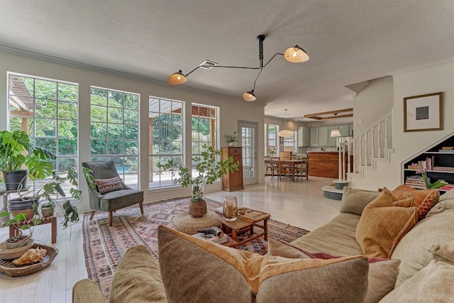 58 E Coldbrook Cir, The Woodlands, TX 77381 - living room featuring a textured ceiling, wood finished floors, and stairway