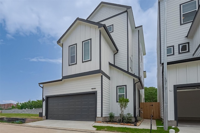 8915 Grovner Pl, Houston, TX 77055 - view of front facade featuring board and batten siding, an attached garage, and concrete driveway