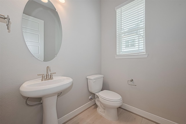 8915 Grovner Pl, Houston, TX 77055 - bathroom featuring toilet and wood finished floors