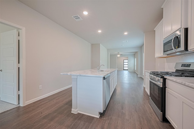 27076 Badger Way, Magnolia, TX 77354 - kitchen featuring appliances with stainless steel finishes, dark wood-style floors, white cabinets, light stone counters, and recessed lighting