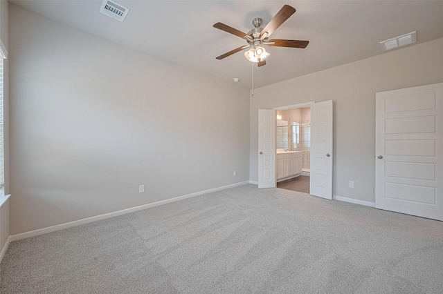 27076 Badger Way, Magnolia, TX 77354 - unfurnished bedroom featuring carpet, connected bathroom, and ceiling fan