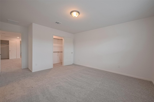 27097 Kestrel Trl, Magnolia, TX 77354 - unfurnished bedroom with light colored carpet, a walk in closet, and a closet