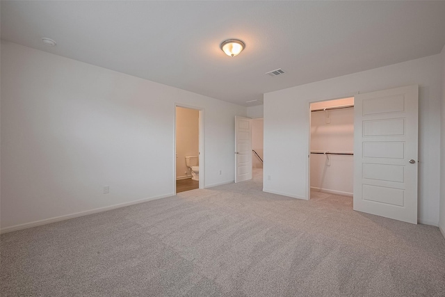 27097 Kestrel Trl, Magnolia, TX 77354 - unfurnished bedroom with light colored carpet, a walk in closet, a closet, and ensuite bath