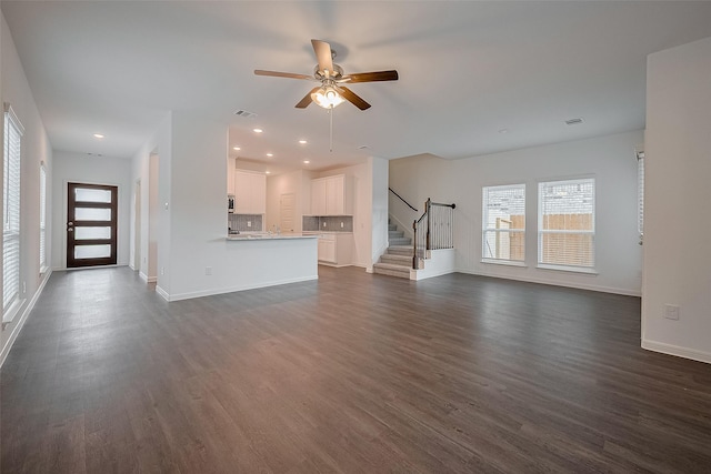 27097 Kestrel Trl, Magnolia, TX 77354 - unfurnished living room with stairs, ceiling fan, dark wood-style flooring, and recessed lighting