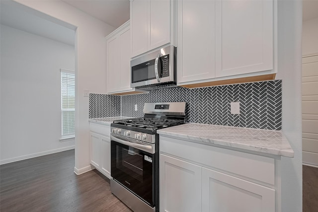 27097 Kestrel Trl, Magnolia, TX 77354 - kitchen featuring appliances with stainless steel finishes, decorative backsplash, dark wood-style flooring, white cabinetry, and light stone countertops