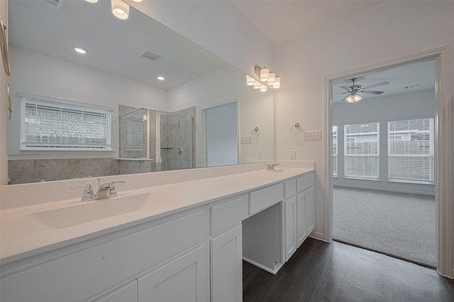 27097 Kestrel Trl, Magnolia, TX 77354 - full bathroom with double vanity, healthy amount of natural light, a tile shower, a ceiling fan, and recessed lighting