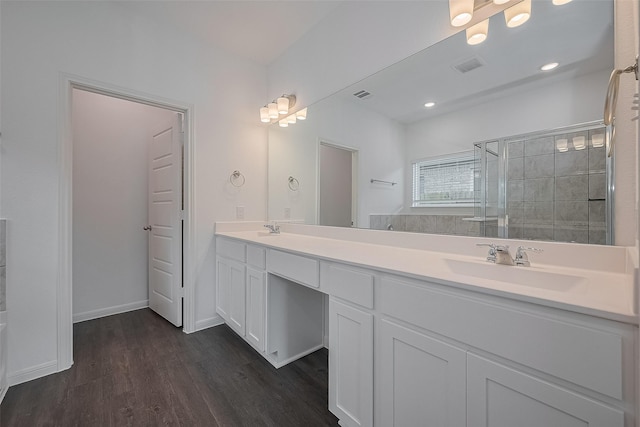 27097 Kestrel Trl, Magnolia, TX 77354 - bathroom featuring double vanity, a shower stall, and wood finished floors