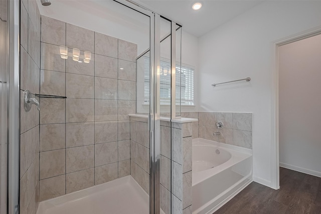 27097 Kestrel Trl, Magnolia, TX 77354 - full bath with a stall shower, a bath, and wood finished floors