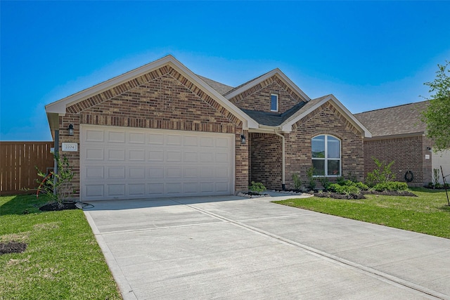 2204 Port Jackson, Texas City, TX 77568 - view of front facade featuring brick siding, driveway, a garage, and roof with shingles