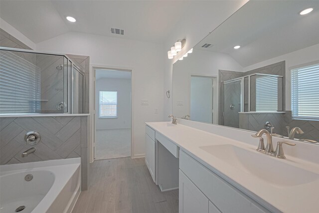2204 Port Jackson, Texas City, TX 77568 - bathroom with lofted ceiling, a stall shower, a bath, double vanity, and wood finished floors