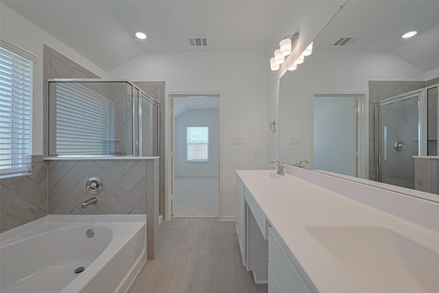 2204 Port Jackson, Texas City, TX 77568 - bathroom featuring vaulted ceiling, a garden tub, a stall shower, wood finished floors, and double vanity