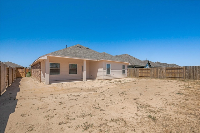 2204 Port Jackson, Texas City, TX 77568 - rear view of house with a fenced backyard and roof with shingles