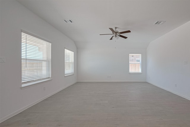 2204 Port Jackson, Texas City, TX 77568 - empty room with healthy amount of natural light, a ceiling fan, wood finished floors, and vaulted ceiling