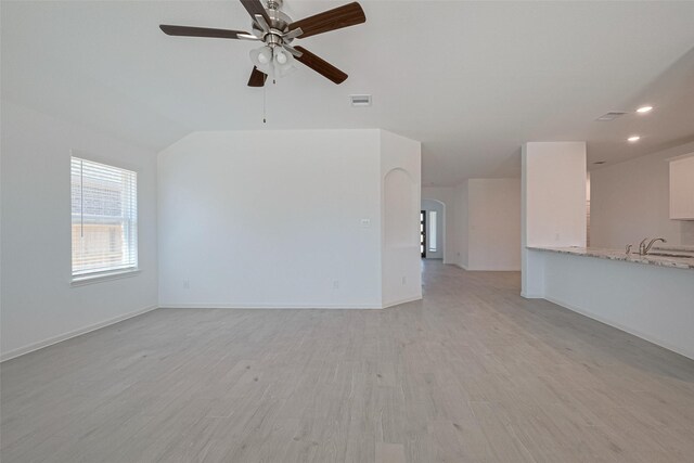 2204 Port Jackson, Texas City, TX 77568 - unfurnished living room with a ceiling fan, arched walkways, light wood finished floors, recessed lighting, and vaulted ceiling