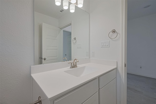 2204 Port Jackson, Texas City, TX 77568 - bathroom featuring vanity, a chandelier, a textured wall, and wood finished floors